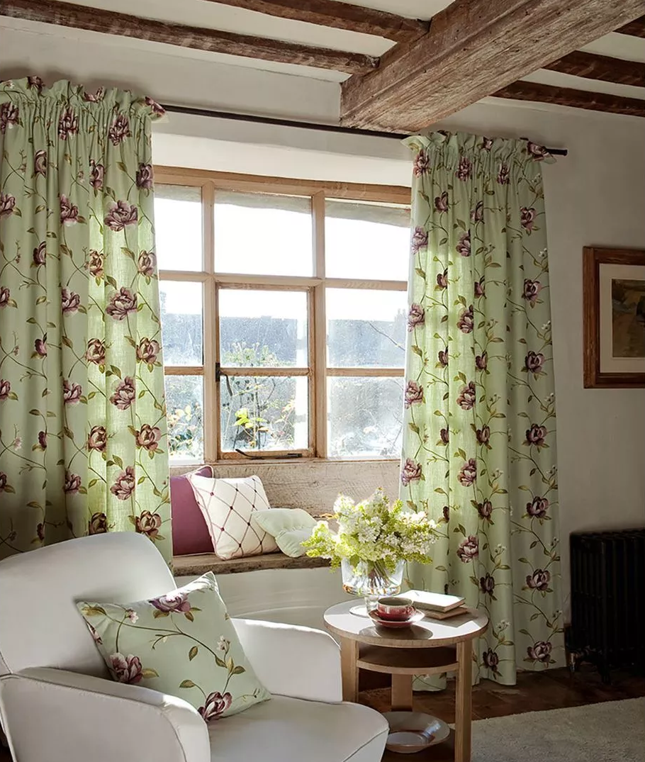 Green printed linen curtains with a matching linen cushion